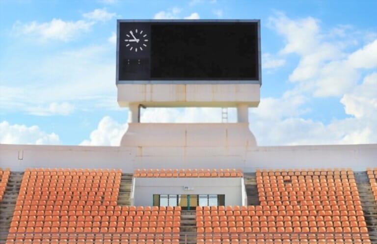 Scoreboard, orange seat in stadium with cloud and blue sky backg Scoreboard, orange seat in stadium with cloud and blue sky backg
