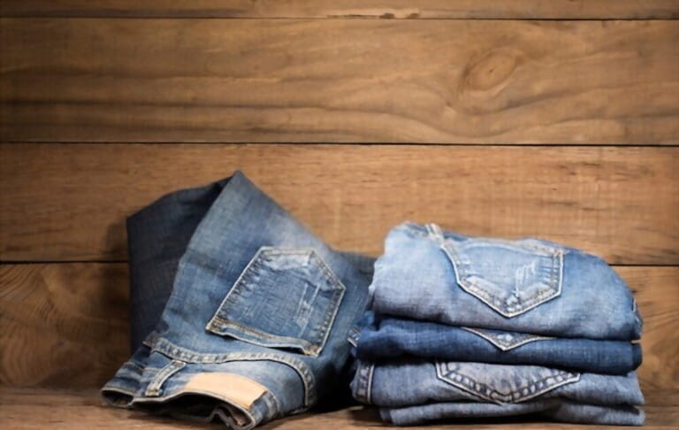 jeans stacked on a wooden background