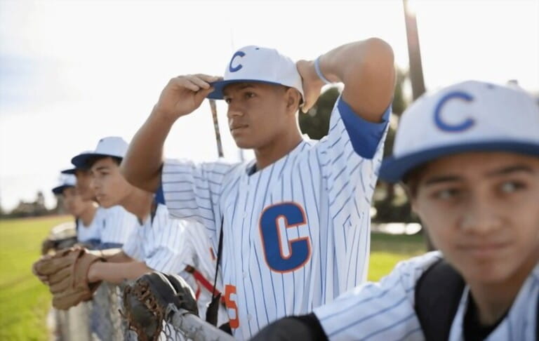 Determined baseball player adjusting hat