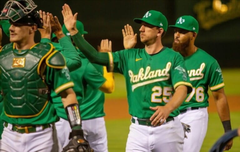 Sean Murphy, Stephen Piscotty, Dermis Garcia, and the Oakland Athletics high five after beating the Texas Rangers at the Oakland Coliseum.