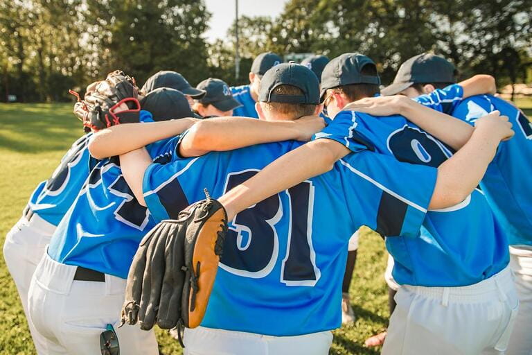 Group of baseball players standing together on the playground