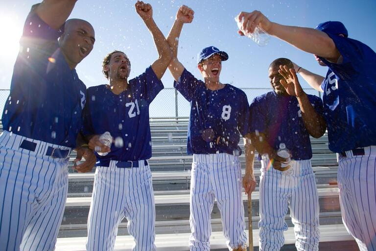 Baseball team celebrating victory and cheering Baseball team celebrating victory and cheering