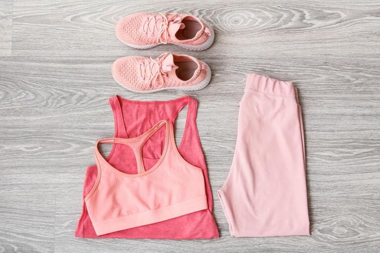 Sportswear and shoes on light wooden background Sportswear and shoes on light wooden background