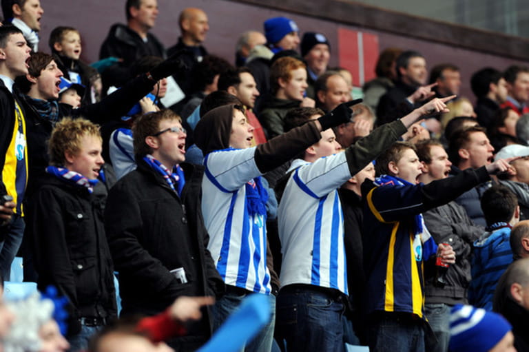 Football fans chanting at at match