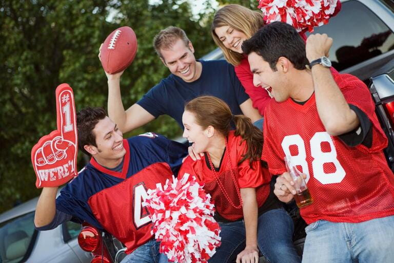 Group of friends at a football tailgating party outside