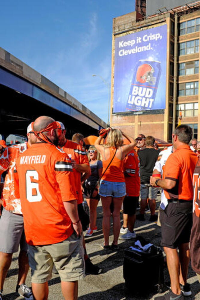 Cleveland Browns football fans gather in a parking lot in downtown Cleveland, Ohio, USA to tailgate prior to a 2019 season game. Many fans, dressed in Browns football Jerserys, show up many hours before the game to participate in the infamous tailgating parties that are spread out throughout downtown Cleveland.